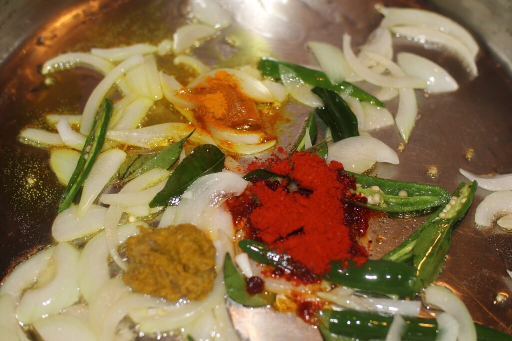 Add in turmeric, crushed ginger and garlic, and Kashmiri chilli powder.