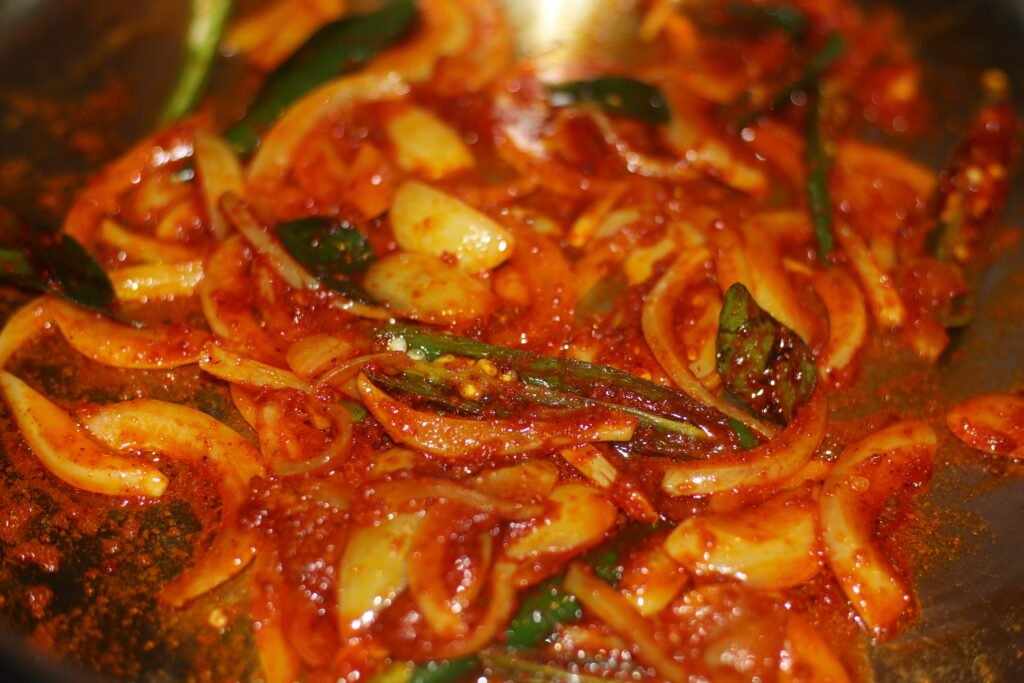 Stir in turmeric, crushed ginger and garlic, and Kashmiri chilli powder.