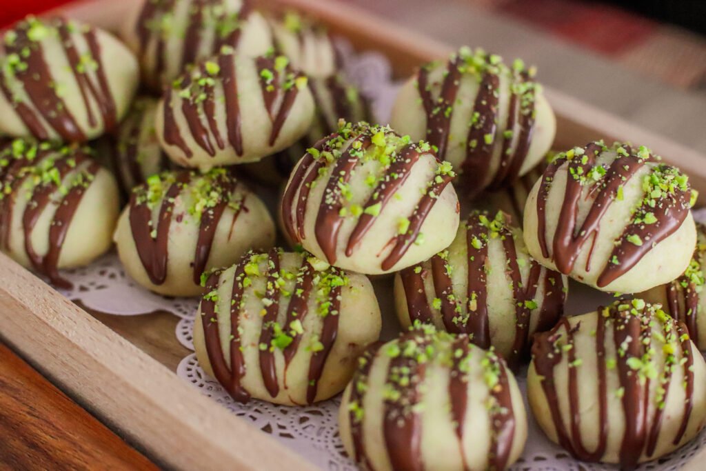 Chocolate drizzle over cooled eggless shortbread balls
