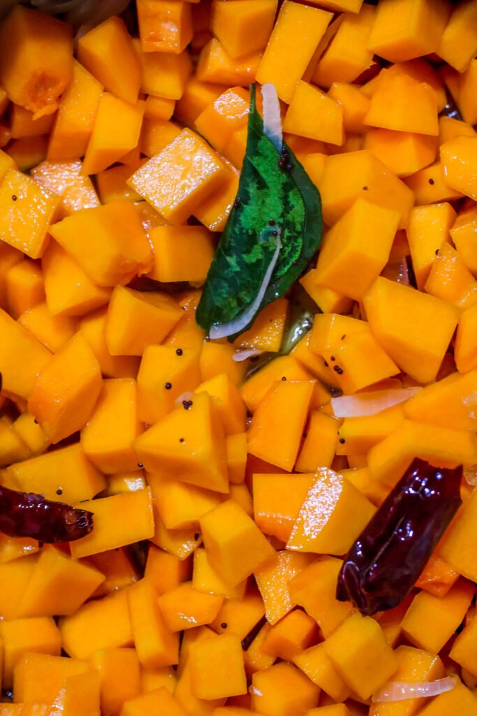 Cubed butternut added to spiced onion mixture in pot