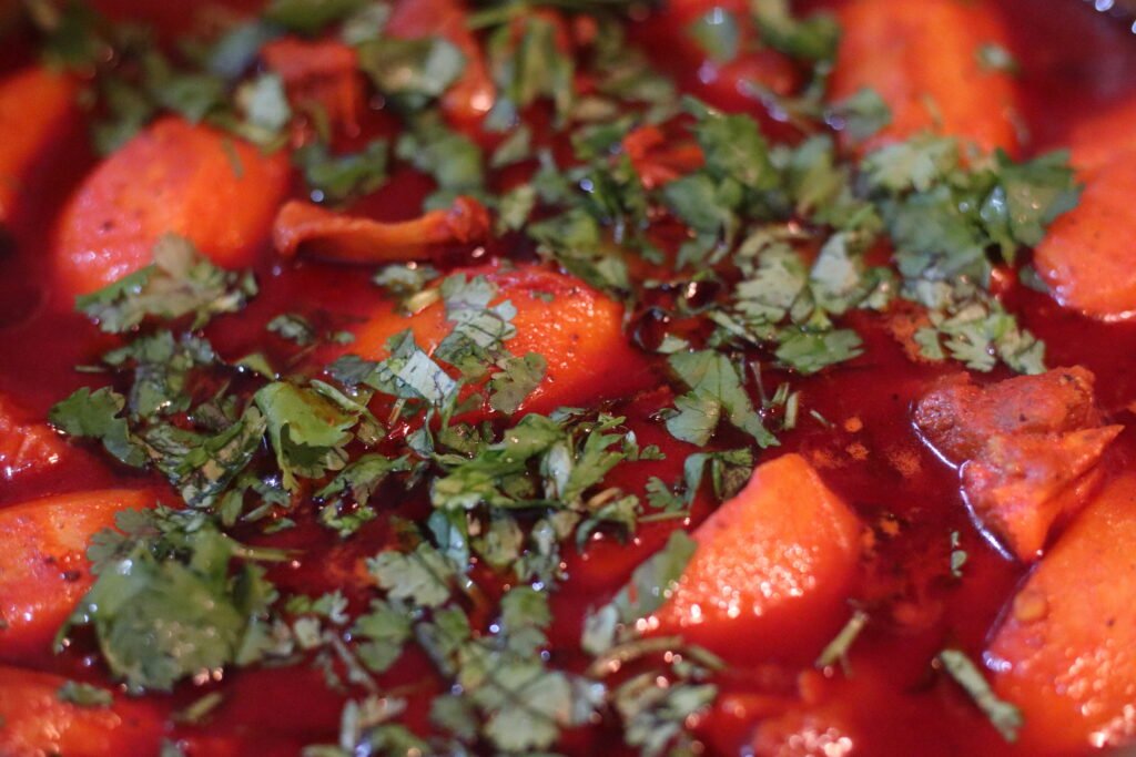 Durban mutton curry served in a bowl garnished with fresh coriander