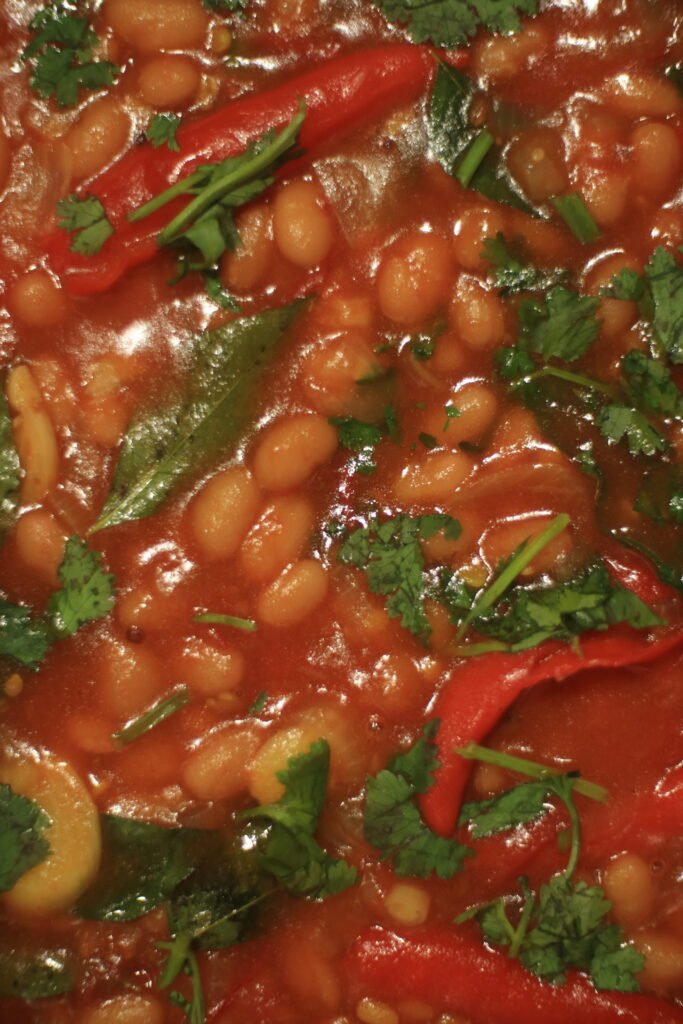 Close-up of spicy baked beans garnished with coriander