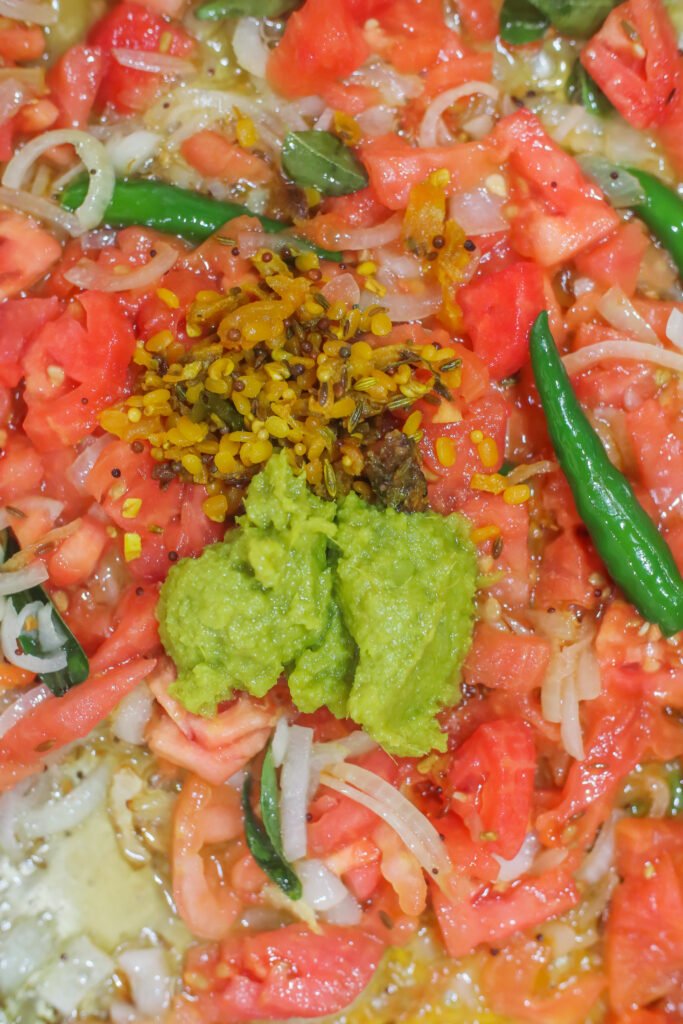 ginger garlic paste and vadouvan added to tomato onion mixture for south african crab curry