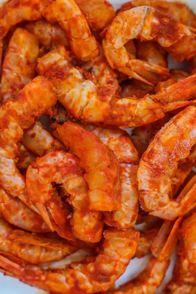 prawns marinating in kashmiri chilli and turmeric