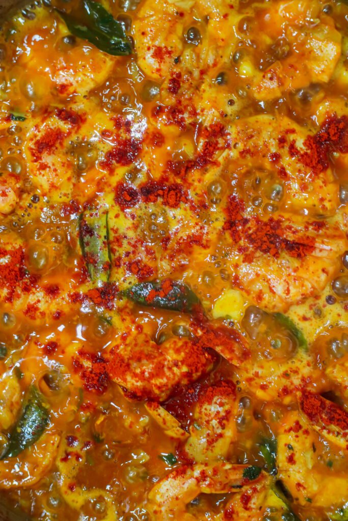 hot sauce and chilli powder added to garlic butter prawns