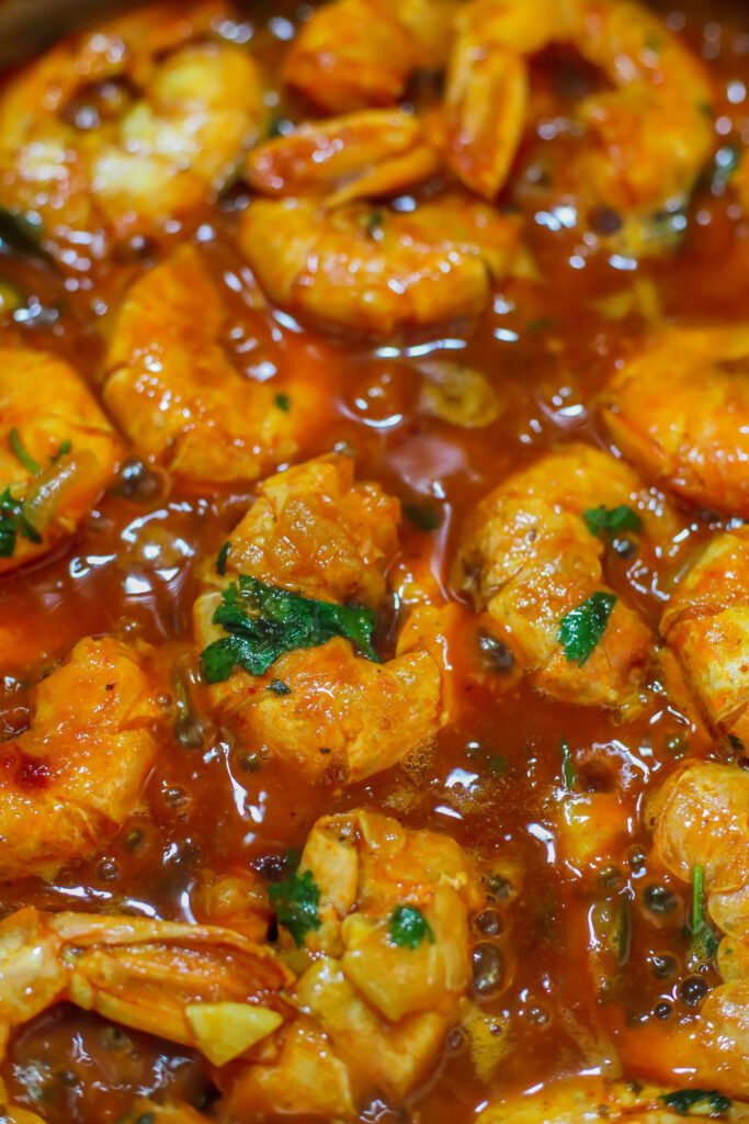 durban chilli garlic butter prawns simmering until orange