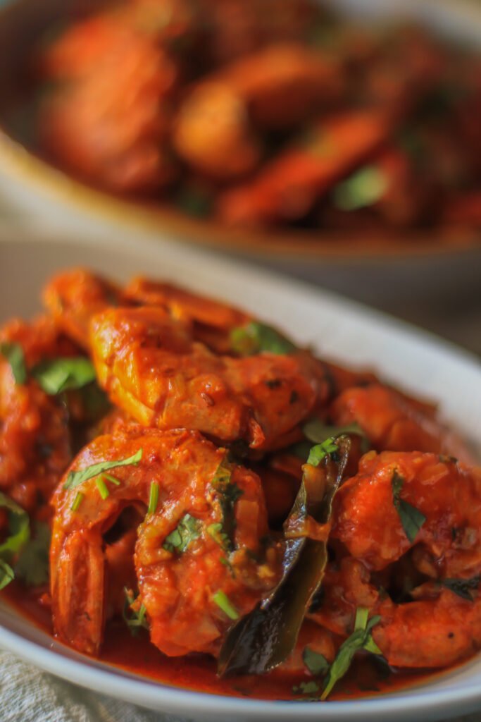 durban chilli garlic butter prawns garnished with coriander