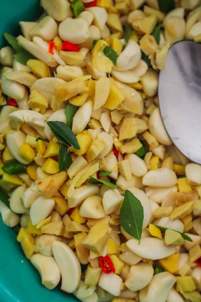 ginger, garlic, red and green chillies and curry leaves combined in a large bowl