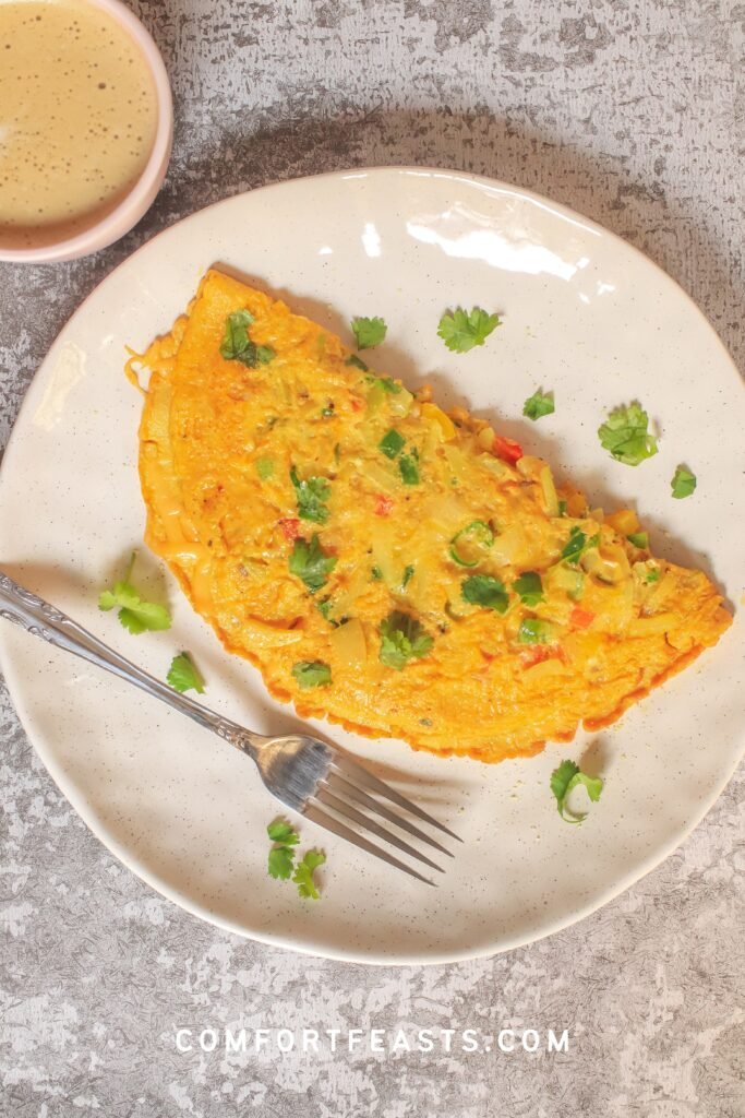 Masala omelette served with coffee and garnished with fresh coriander