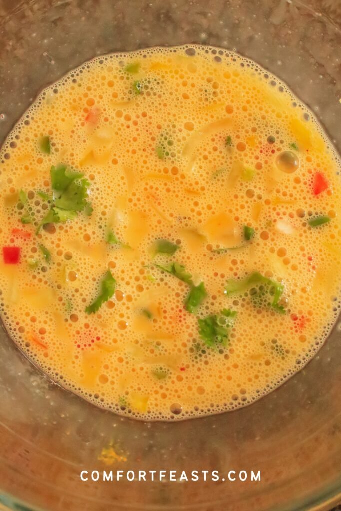 Masala omelette egg mixture with spices and vegetables
